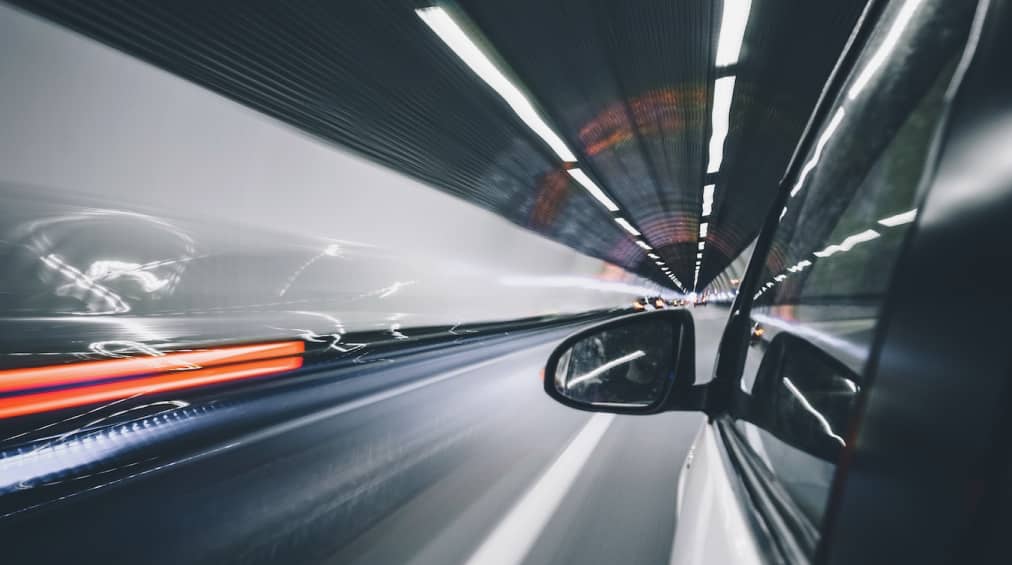 Artistic image of car driving through a tunnell